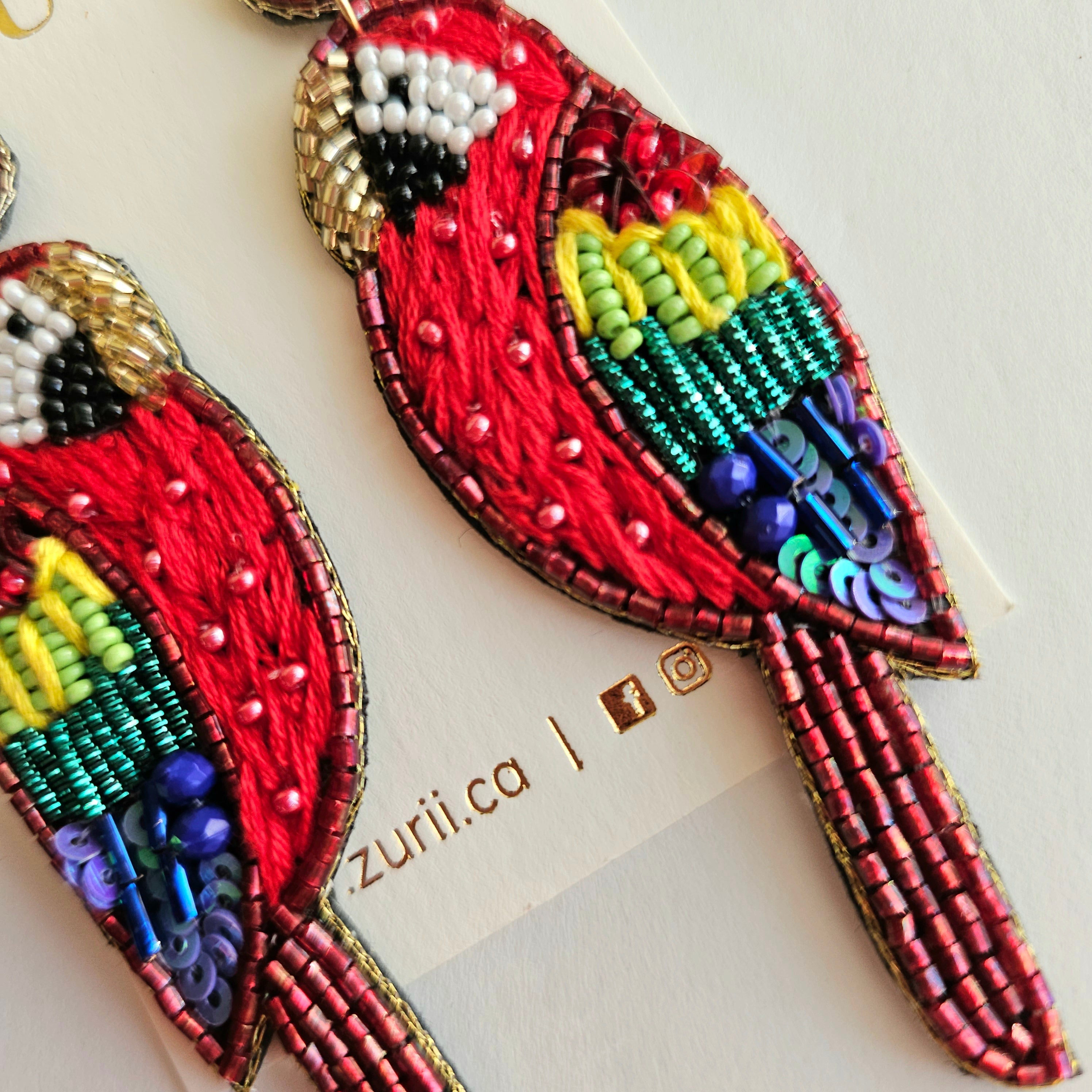 Red Macaw Earrings by Zurii – Handmade ethical Earrings from sariKNOTsari using upcycled silk. Designed in Canada for travel and slow fashion, loved from Toronto to LA to Sydney. Featuring Zsiska, Bryn Walker and Artisan Leather coats by Rejean Pepin, Pepin designs