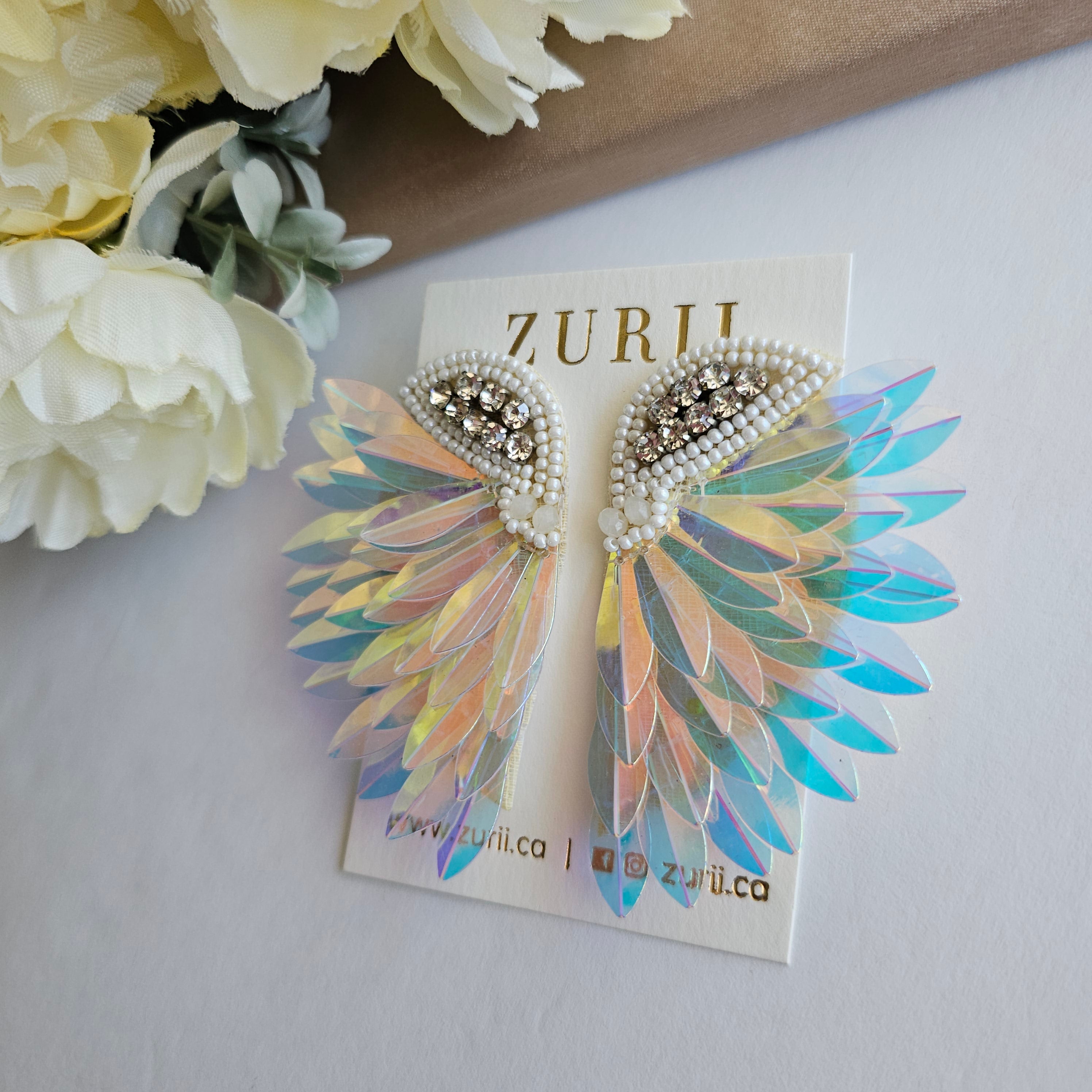 Iridescent Angel Wings Earrings by Zurii – Handmade ethical Earrings from sariKNOTsari using upcycled silk. Designed in Canada for travel and slow fashion, loved from Toronto to LA to Sydney. Featuring Zsiska, Bryn Walker and Artisan Leather coats by Rejean Pepin, Pepin designs