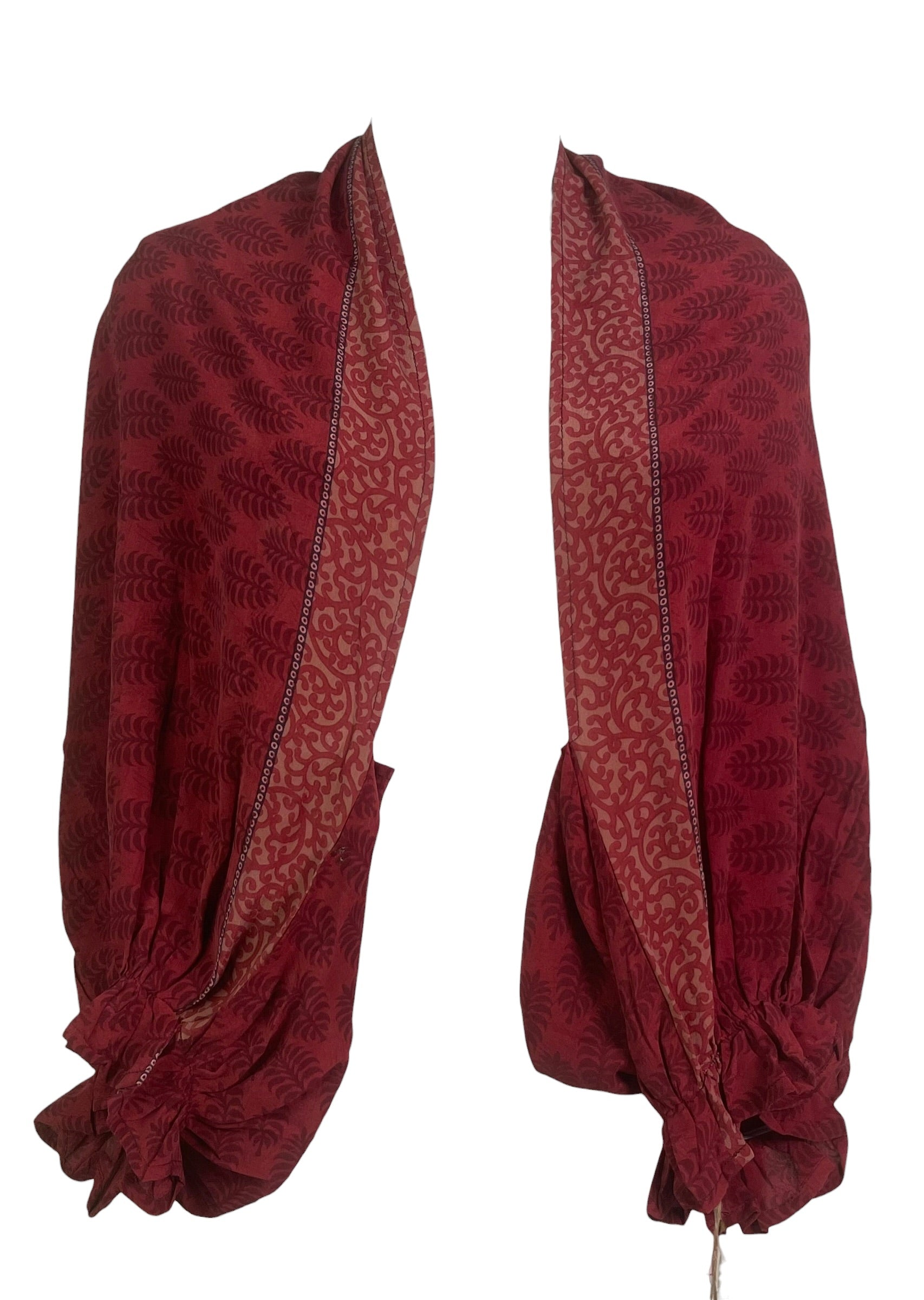 Red patterned fabric draped over a white background