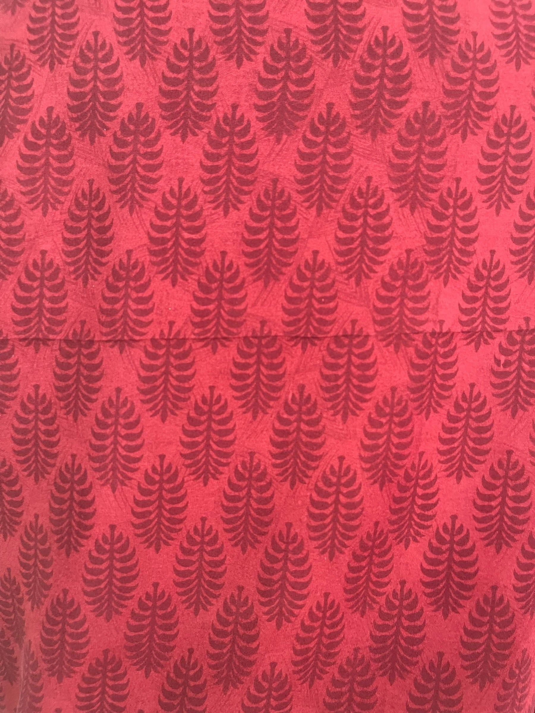 Red fabric with black leaf pattern