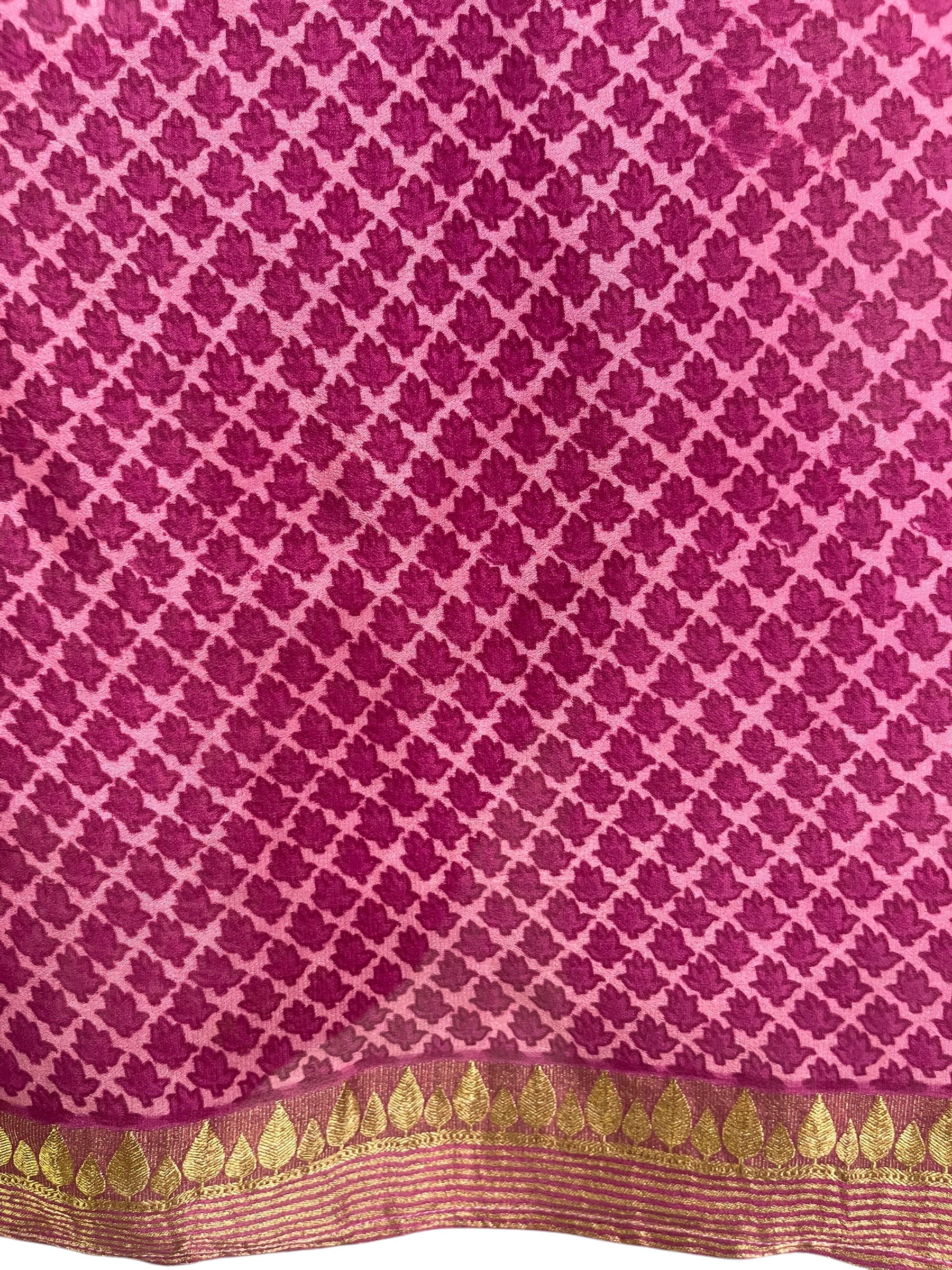 Pink fabric with a white lattice pattern and gold leaf border