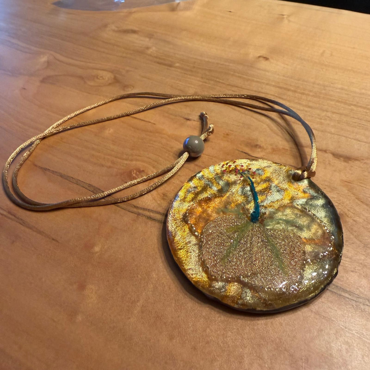 Golden Flower Fairy Hat Pendant by Kristine’s Kreations – Handmade ethical Necklace from sariKNOTsari using upcycled silk. Designed in Canada for travel and slow fashion, loved from Toronto to LA to Sydney. Featuring Zsiska, Bryn Walker and Artisan Leather coats by Rejean Pepin, Pepin designs